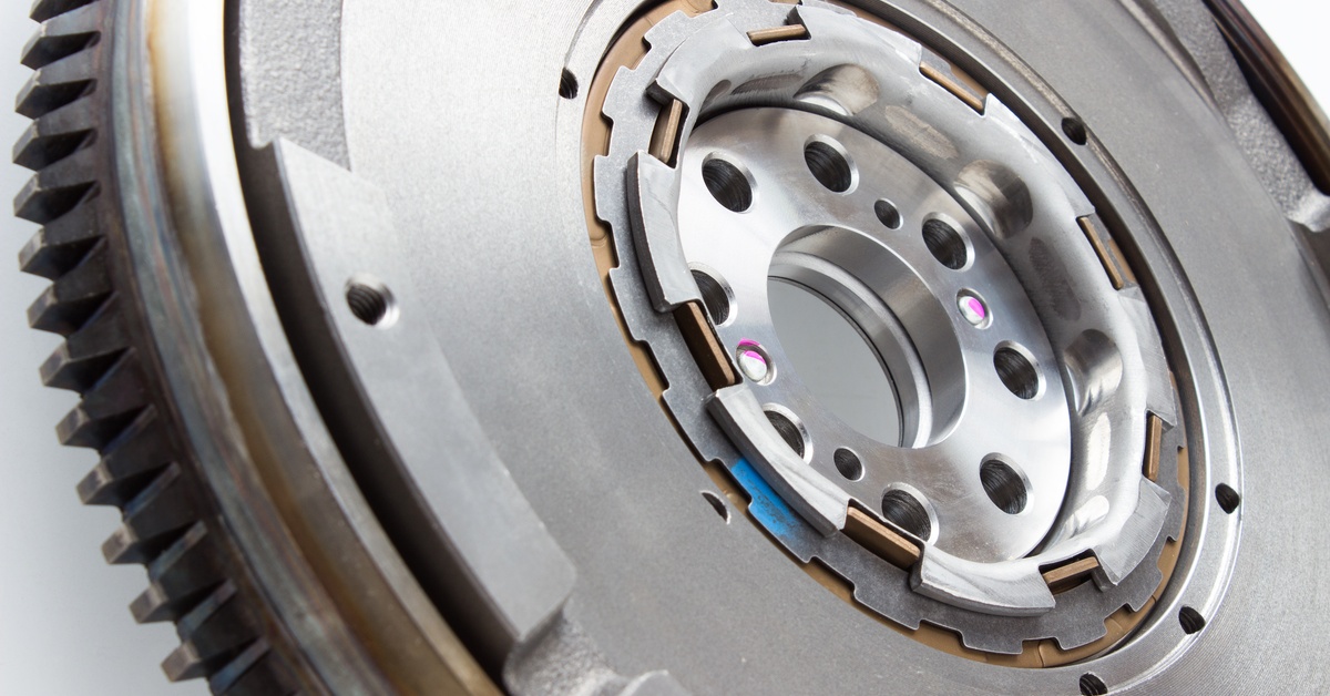 A close-up of an automotive flywheel dampener part for a diesel engine vehicle against a white background.